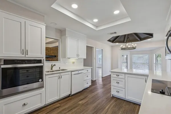 a kitchen with a sink stainless steel appliances and cabinets