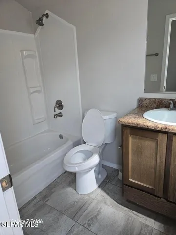 a bathroom with a granite countertop toilet a sink and bathtub