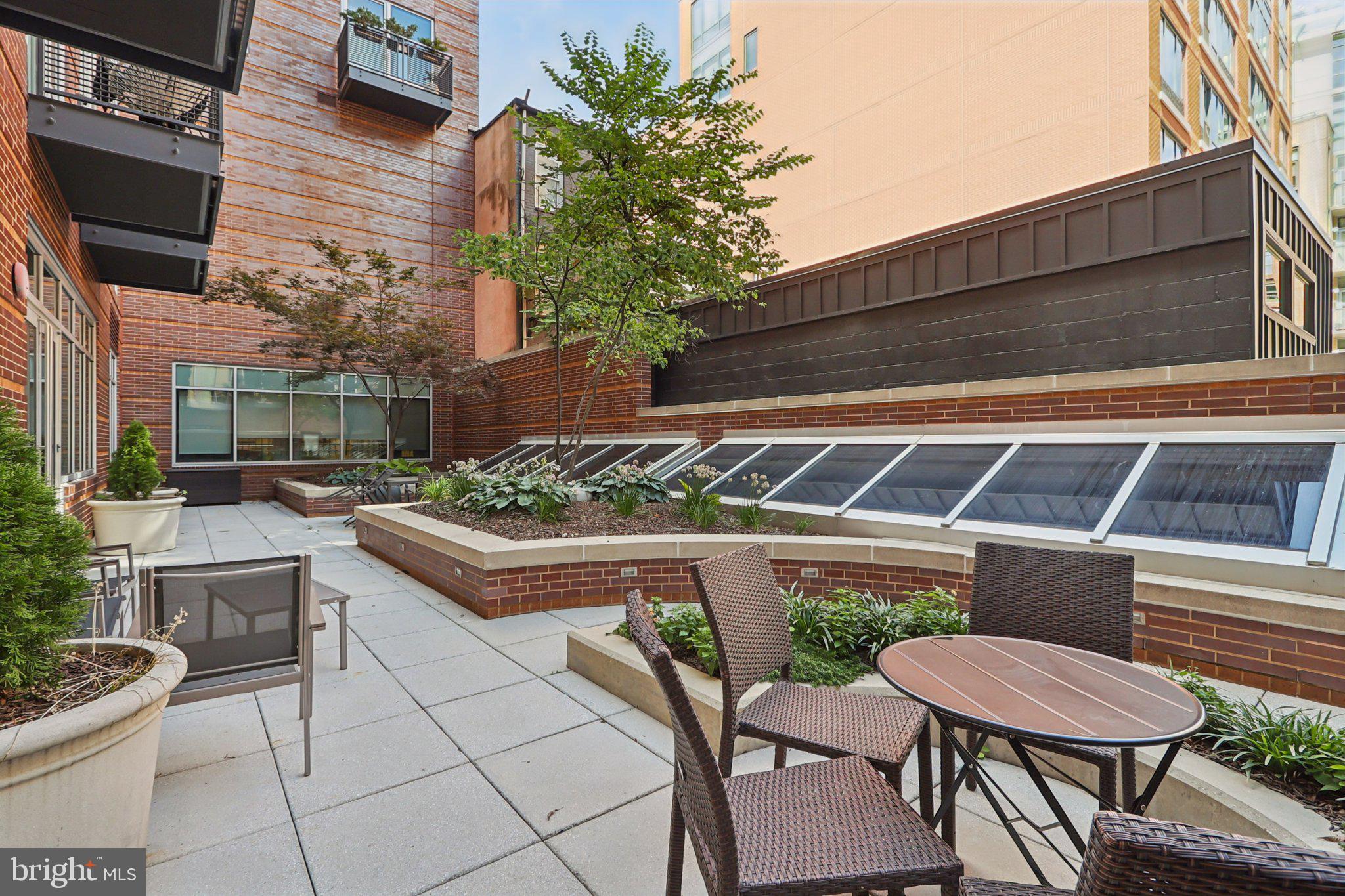 1515 15th Street Northwest, Unit 406A Washington, DC 20005 - Photo 19 of 26 a view of a backyard with a chair and potted plants