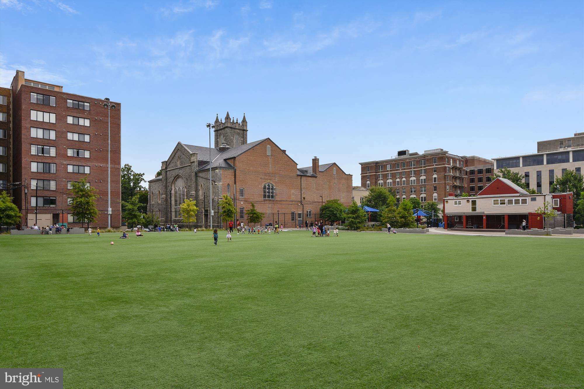 1515 15th Street Northwest, Unit 406A Washington, DC 20005 - Photo 24 of 26 a view of a big house with a big yard and large trees
