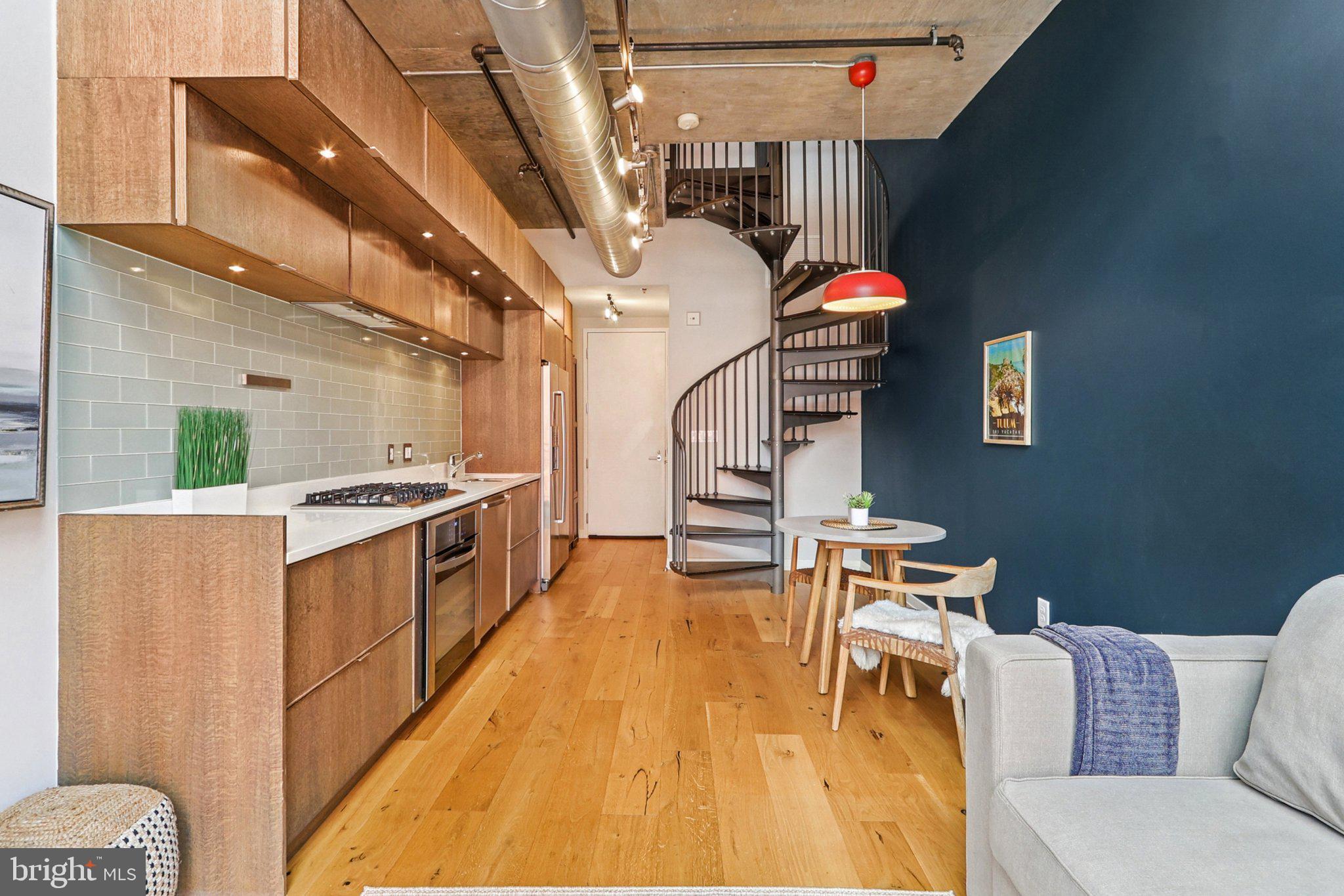 1515 15th Street Northwest, Unit 406A Washington, DC 20005 - Photo 4 of 26 a living room with furniture and a wooden floor