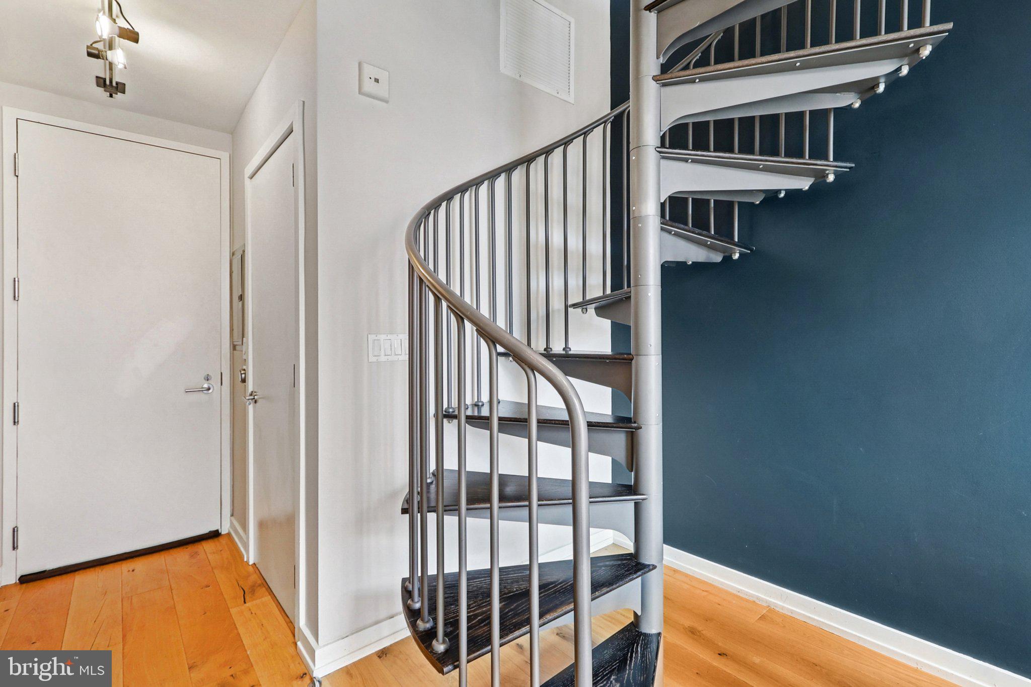 1515 15th Street Northwest, Unit 406A Washington, DC 20005 - Photo 10 of 26 a view of staircase with white walls and a window