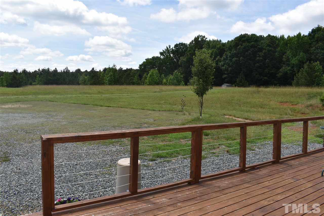 466 Vineyard Ridge Siler City, NC 27344 - Photo 3 of 29 a view of a wooden deck with a yard