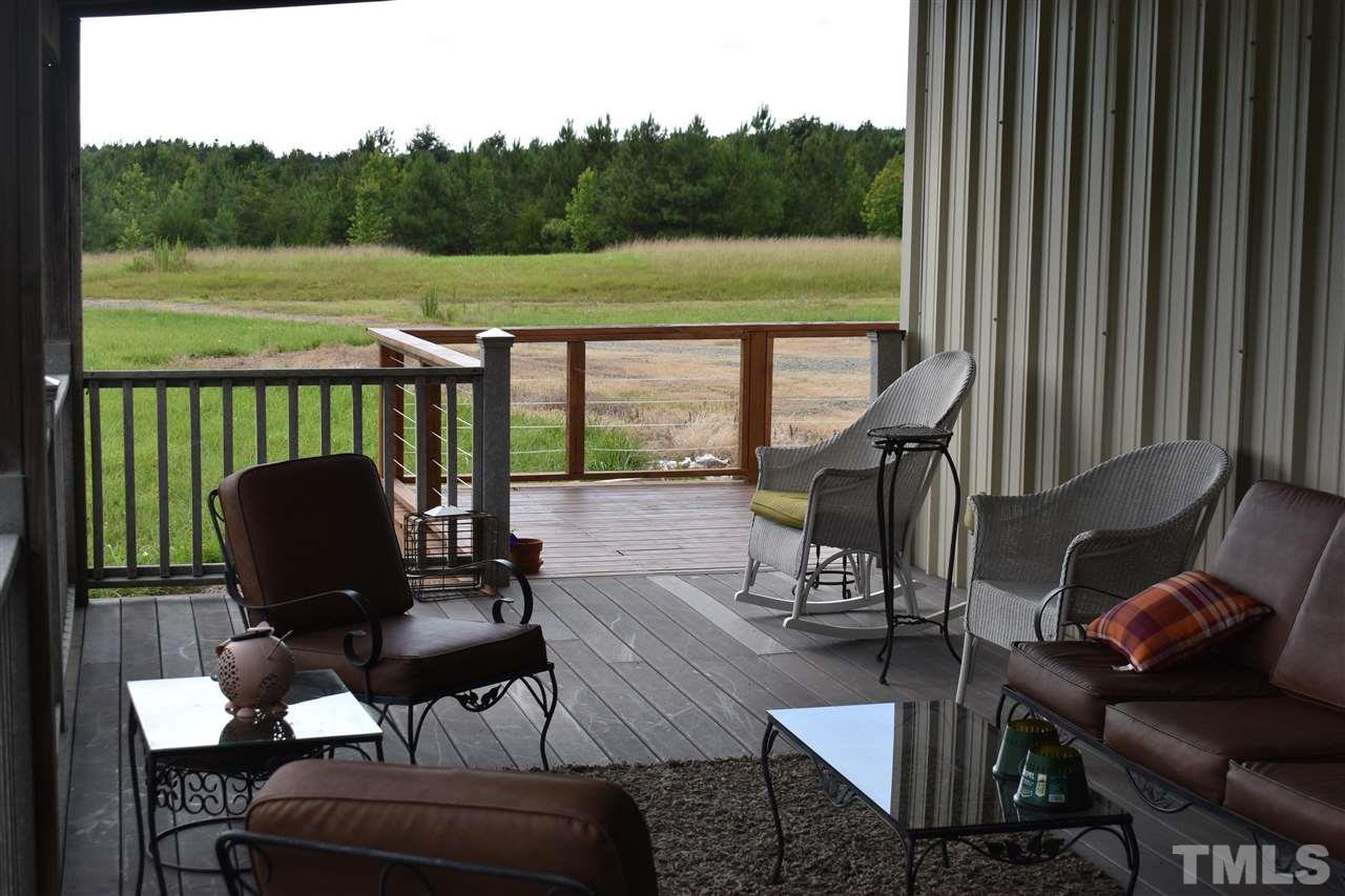 466 Vineyard Ridge Siler City, NC 27344 - Photo 4 of 29 a view of a balcony with chair and table