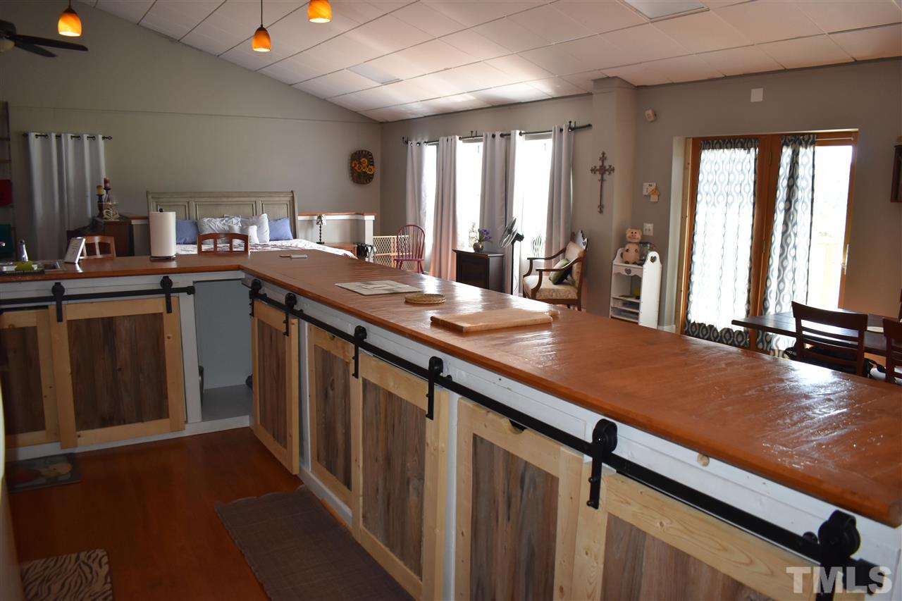466 Vineyard Ridge Siler City, NC 27344 - Photo 9 of 29 a kitchen with center island table and chairs