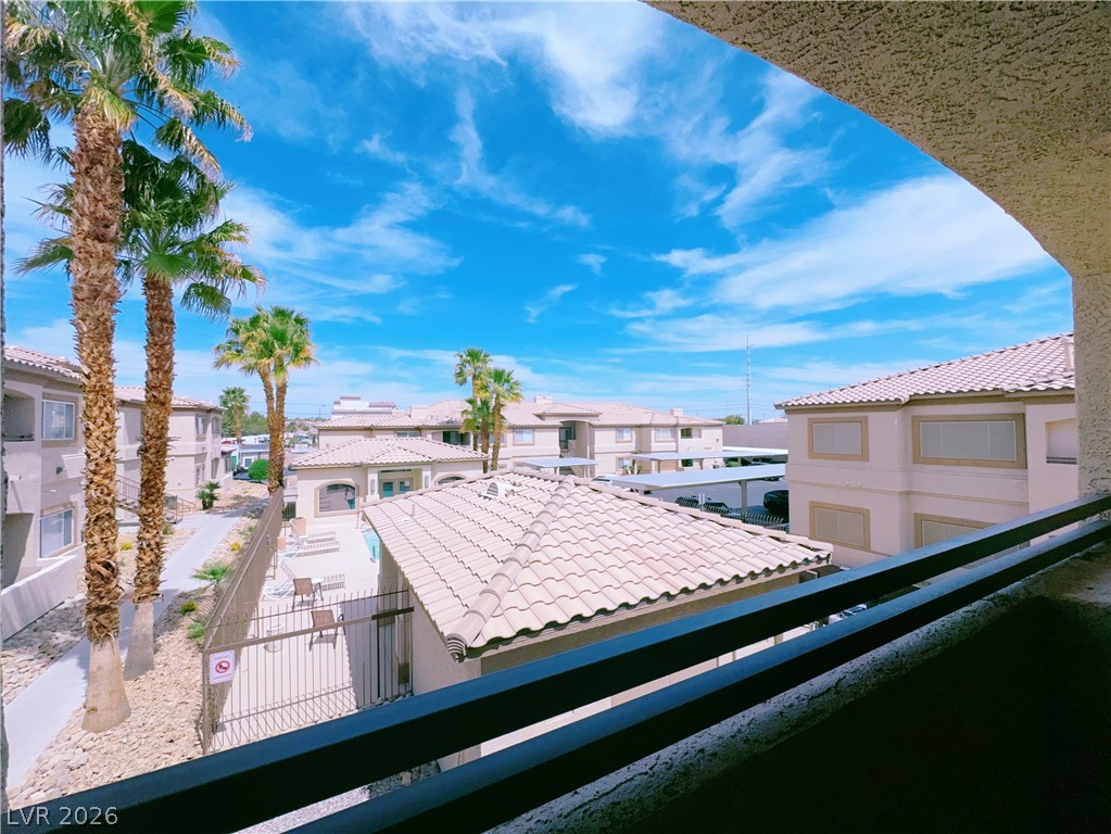 8725 West Flamingo Road, Unit 208 Las Vegas, NV 89147 - Photo 15 of 16 This vibrant complex offers serene views and convenient amenities under a bright sky.