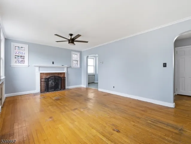 a view of a livingroom with a fireplace and a ceiling fan
