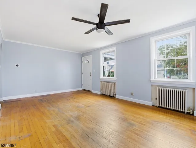 a view of livingroom with hardwood floor and a ceiling fan