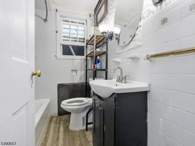 a bathroom with a sink a toilet and mirror