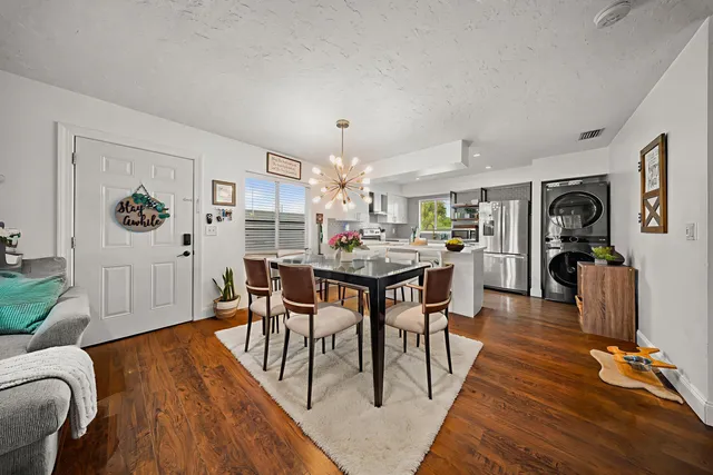 a living room with furniture and kitchen view