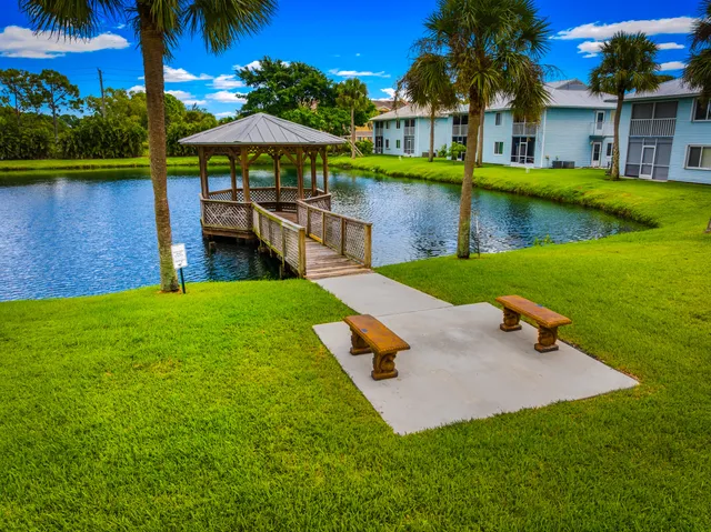 an aerial view of a swimming pool with lounge chairs