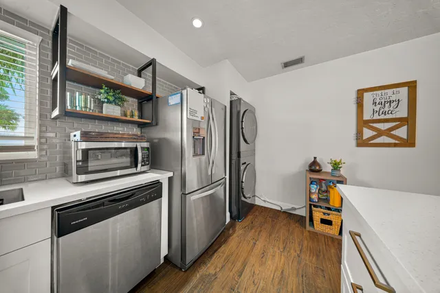 a view of a hallway with mirror and furniture