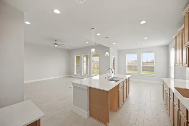 a large white kitchen with a large window