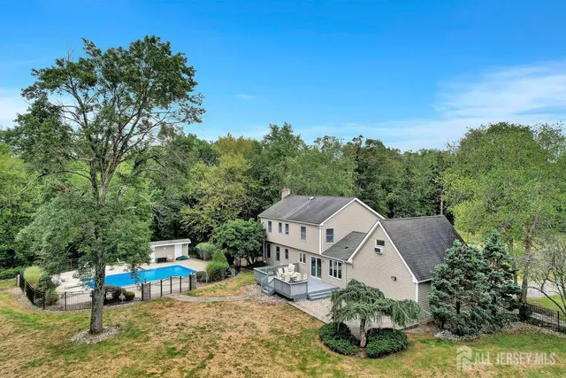 an aerial view of a house with swimming pool garden and mountain view