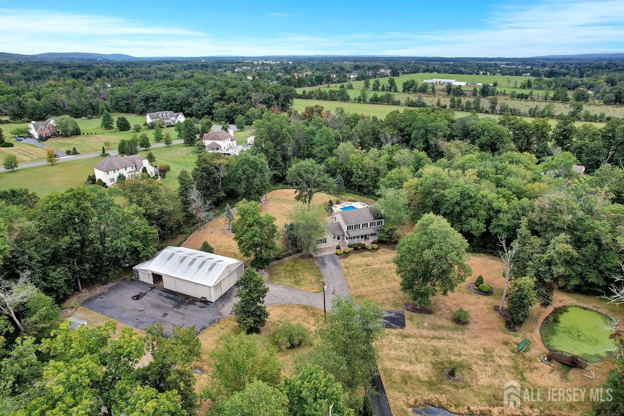 526 County Road, Unit 579 Ringoes, NJ 08551 - Photo 14 of 51 an aerial view of a house with a yard and lake view