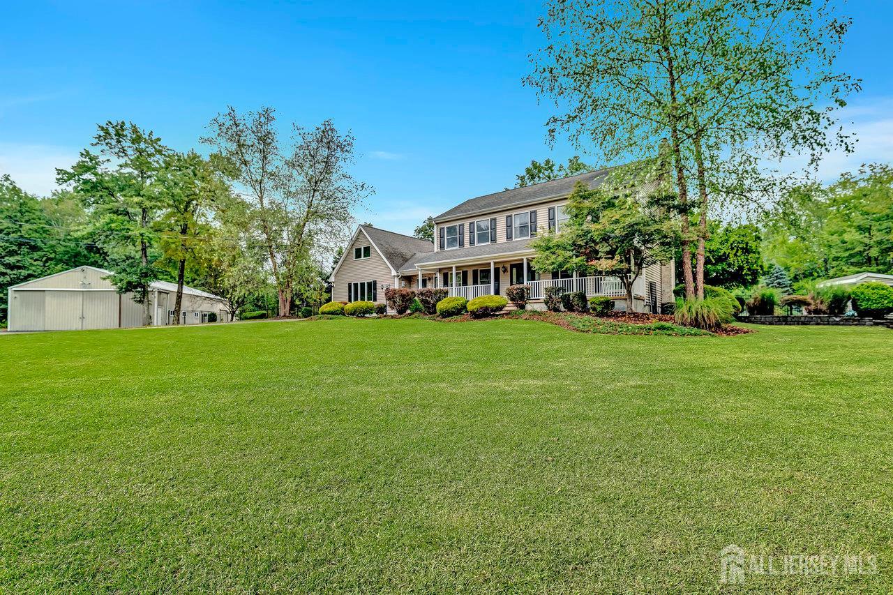 526 County Road, Unit 579 Ringoes, NJ 08551 - Photo 17 of 51 a view of a white house that has a tree in front of it