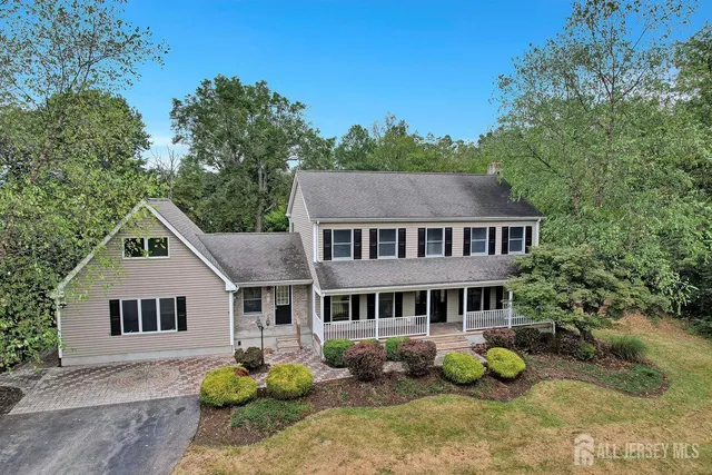 a aerial view of a house next to a yard