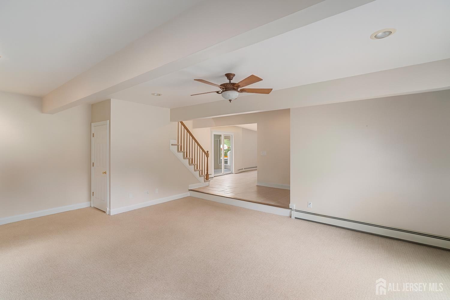 526 County Road, Unit 579 Ringoes, NJ 08551 - Photo 42 of 51 an empty room with a ceiling fan and a window