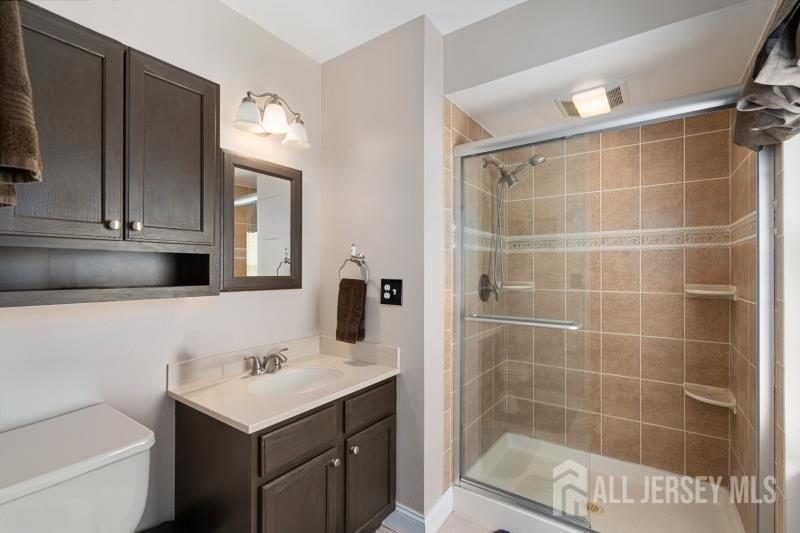 526 County Road, Unit 579 Ringoes, NJ 08551 - Photo 47 of 51 a bathroom with a bathtub shower sink vanity and toilet