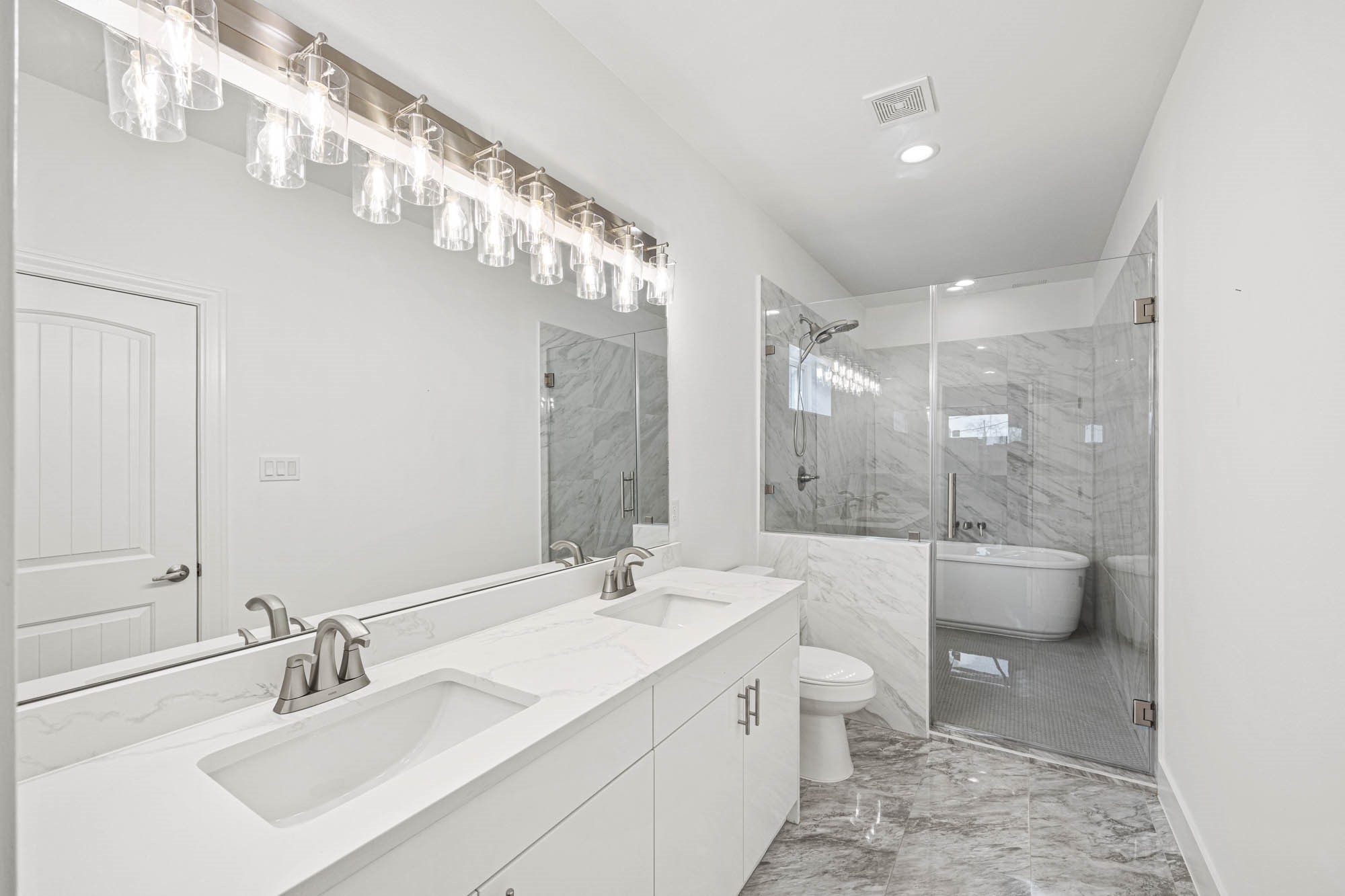 4512 Noble Street Houston, TX 77020 - Photo 14 of 16 a bathroom with a double vanity sink toilet and shower