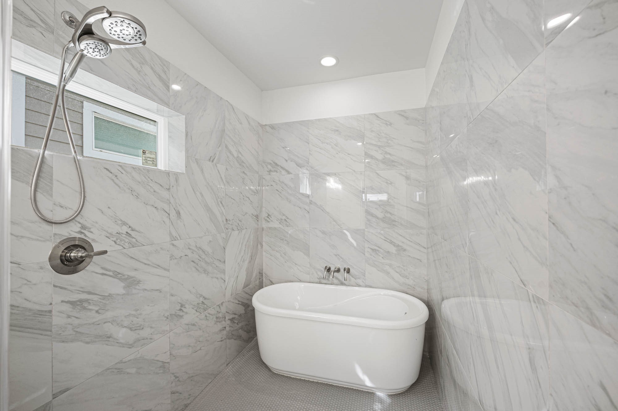 4512 Noble Street Houston, TX 77020 - Photo 15 of 16 a bathroom with a bathtub and shower