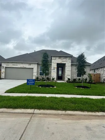 a front view of a house with a yard and a garage