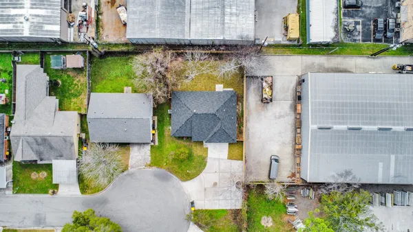 an aerial view of a house with a swimming pool