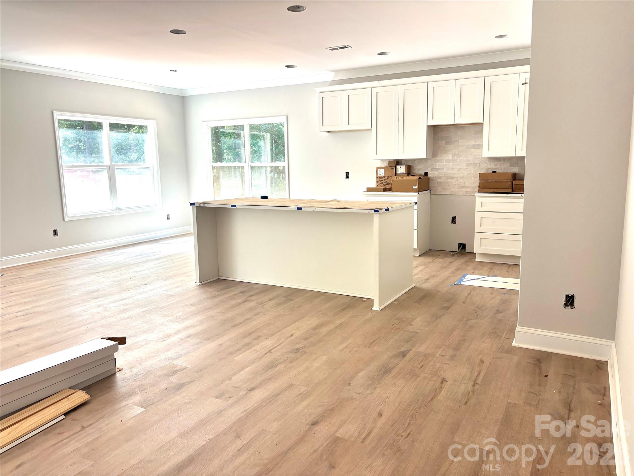 1818 New Salem Road Monroe, NC 28110 - Photo 6 of 8 a kitchen with stainless steel appliances wooden floors and white walls