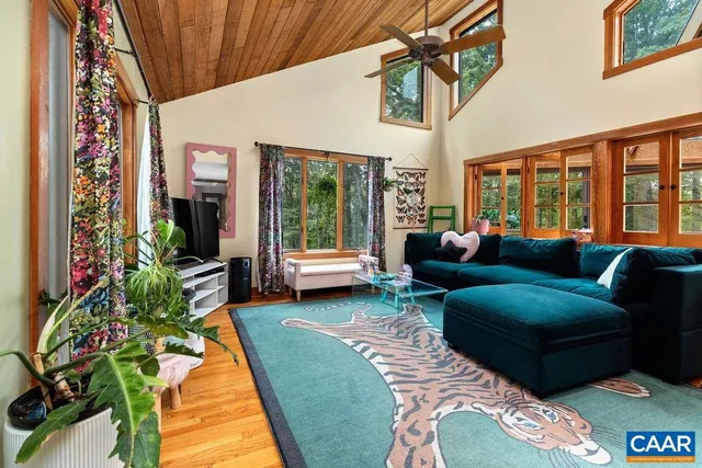 a view of a bedroom with wooden floor and windows