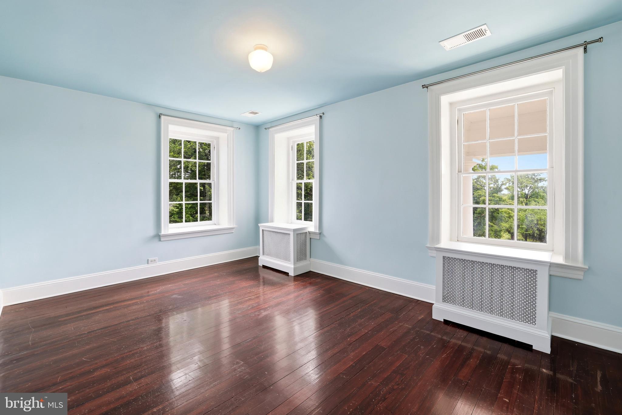 17781 Roxbury Hall Road Leesburg, VA 20175 - Photo 50 of 107 an empty room with wooden floor and windows