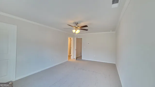 a view of a livingroom with a ceiling fan and window
