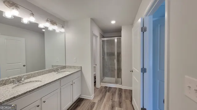 a bathroom with a double vanity sink and a mirror