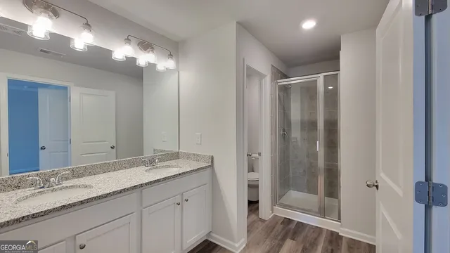 a bathroom with a double vanity sink and a mirror