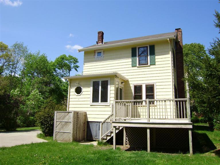 19 Shore Road Bourne, MA 02532 - Photo 17 of 21 a front view of a house with a yard