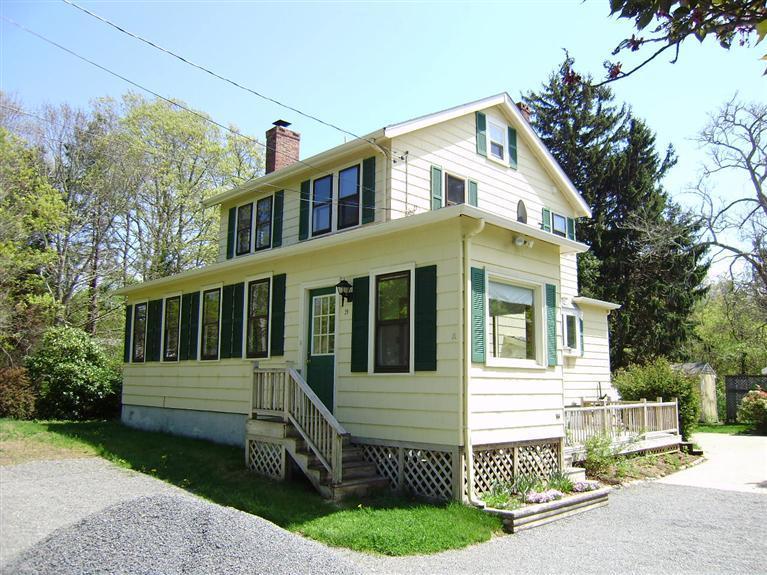 19 Shore Road Bourne, MA 02532 - Photo 20 of 21 a front view of a house with a garden