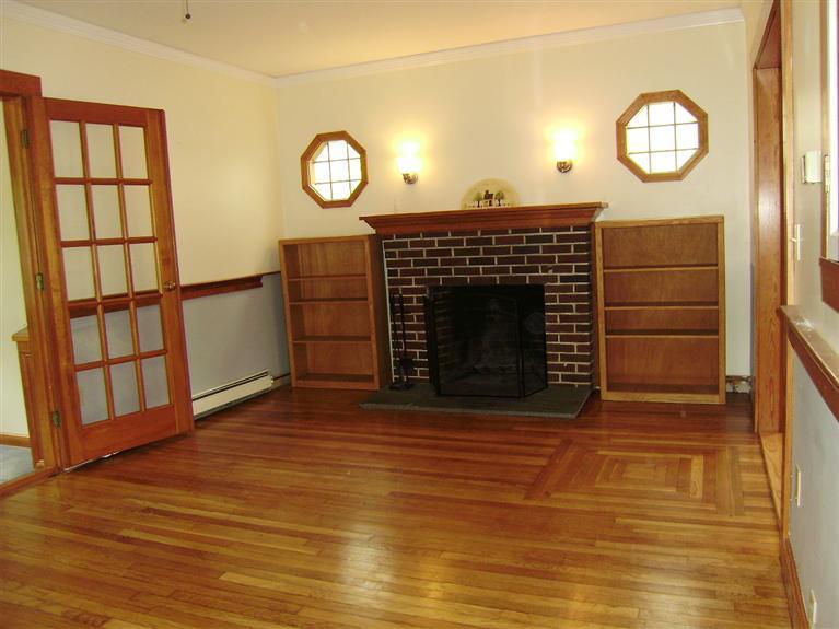 19 Shore Road Bourne, MA 02532 - Photo 3 of 21 a view of a livingroom with wooden floor a fireplace and a window