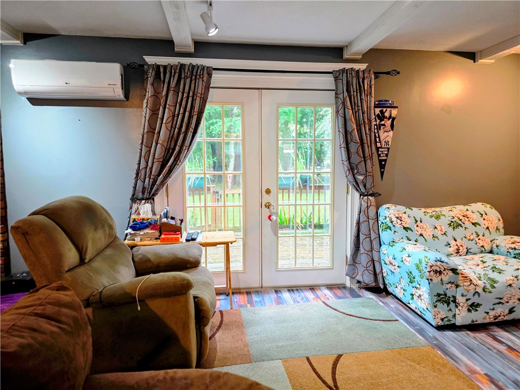 5 Mill Wheel Road Warwick, RI 02886 - Photo 8 of 36 Beamed ceilings wood stove and french doors leading to deck and yard