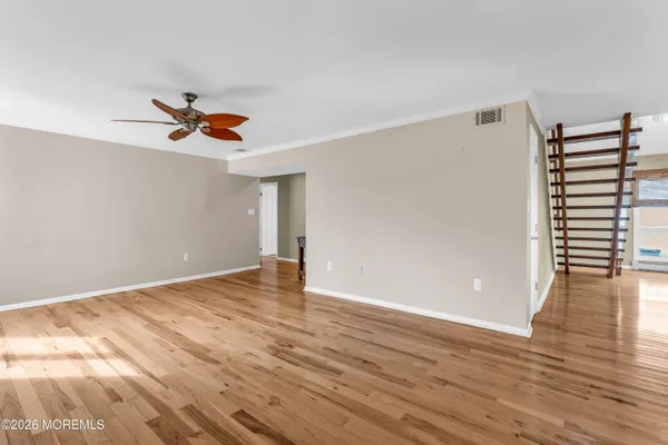 a living room with furniture fireplace and a large window
