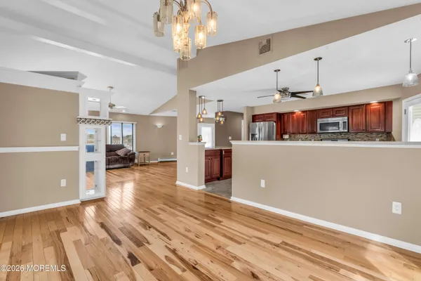 a spacious kitchen with a stove a sink dishwasher and a microwave oven
