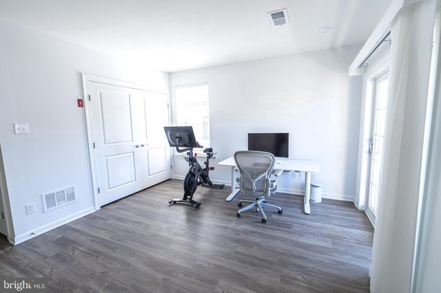 a view of a workspace with wooden floor