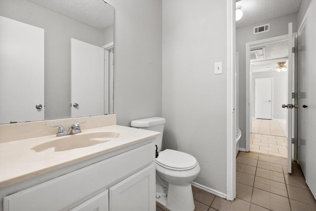 5821 Mansfield Road Arlington, TX 76017 - Photo 17 of 24 a bathroom with a sink a toilet and shower