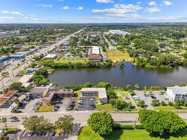 an aerial view of a city with lots of residential buildings lake and ocean view