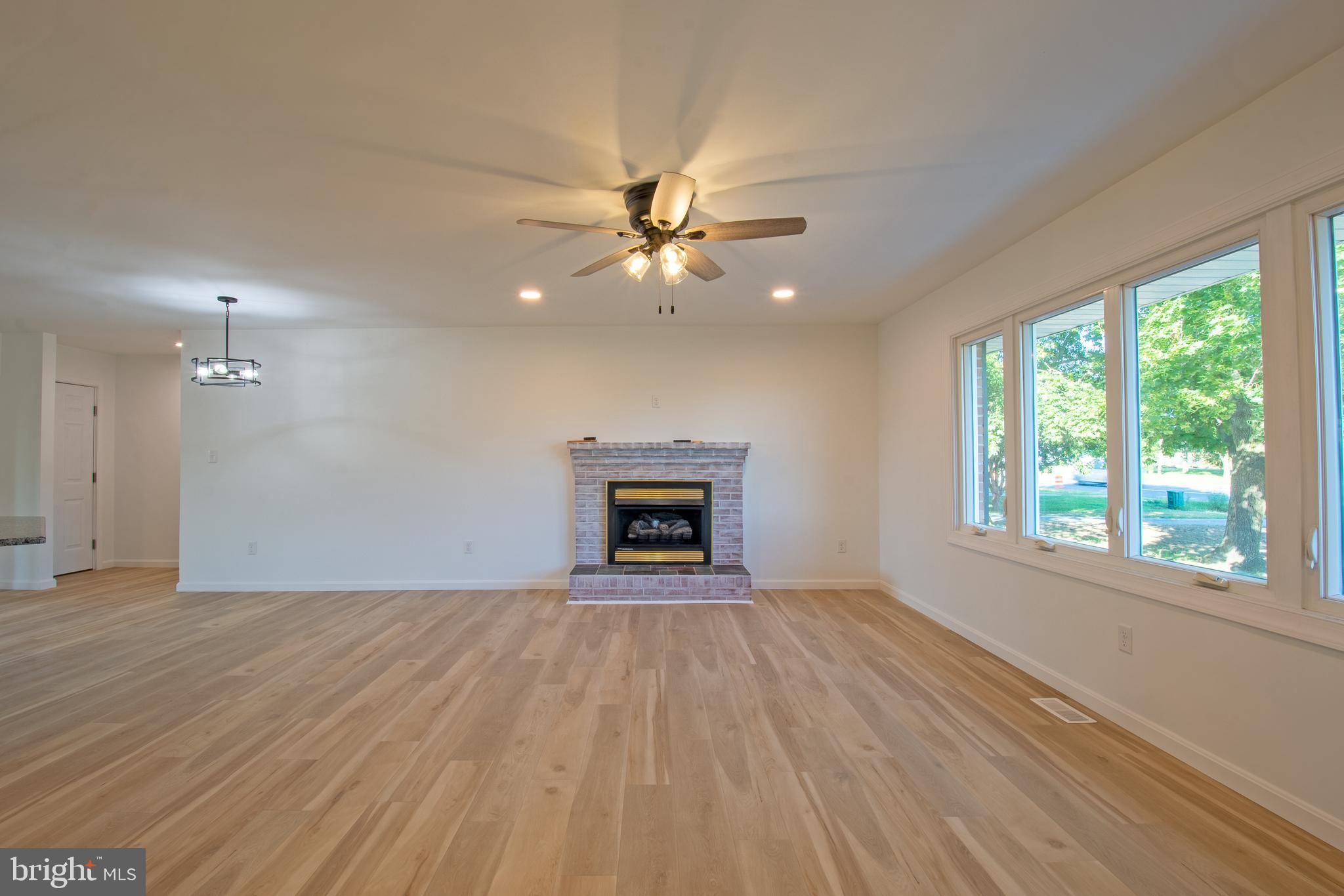 26854 Broadkill Road Milton, DE 19968 - Photo 30 of 56 a view of an empty room with a window and fireplace