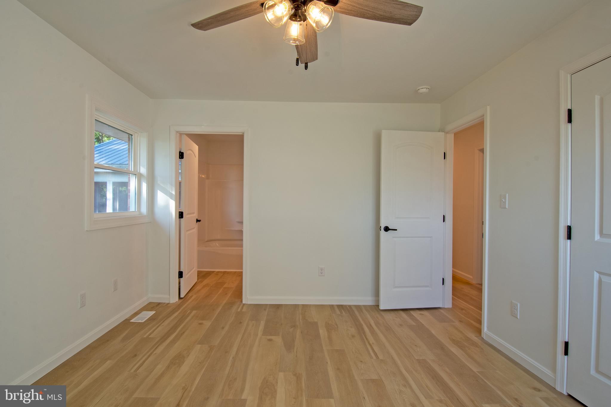 26854 Broadkill Road Milton, DE 19968 - Photo 33 of 56 wooden floor in an empty room with a window