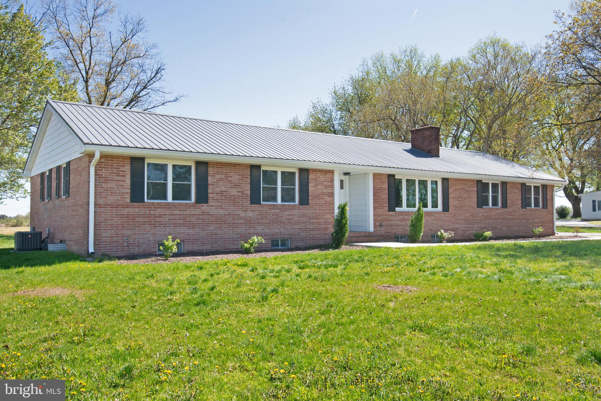 26854 Broadkill Road Milton, DE 19968 - Photo 4 of 56 a front view of a house with a yard