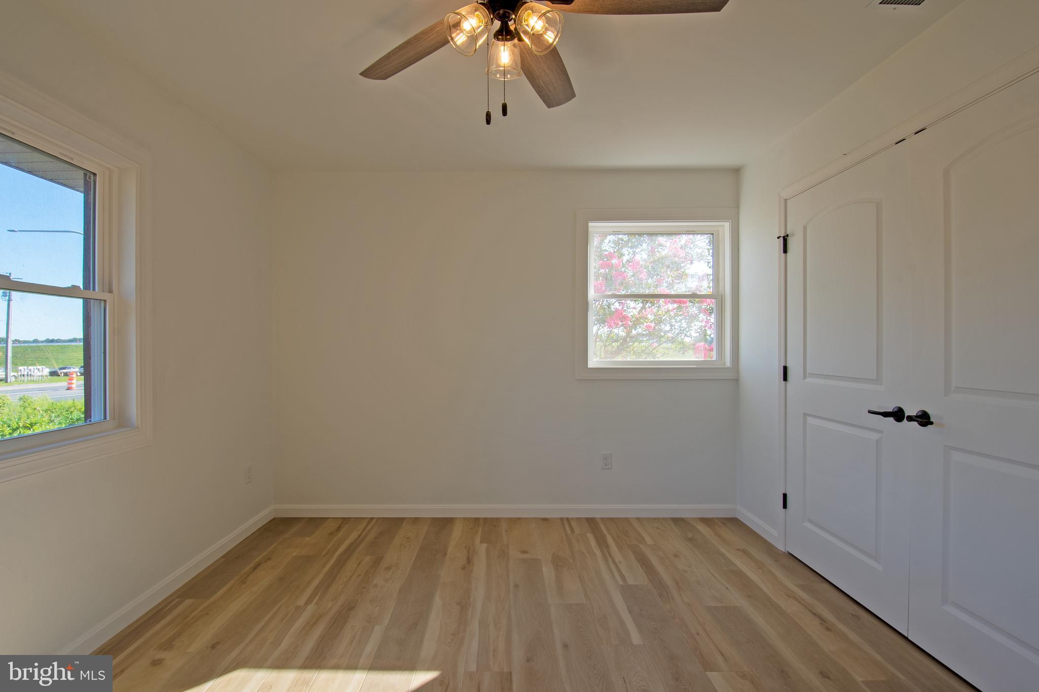 26854 Broadkill Road Milton, DE 19968 - Photo 42 of 56 wooden floor in an empty room with a window