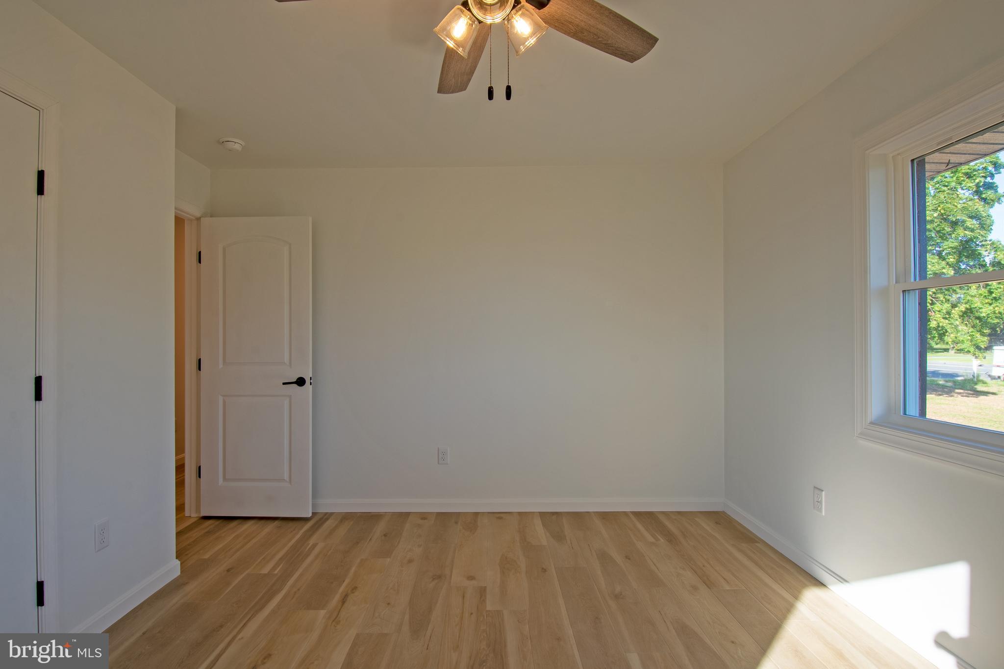 26854 Broadkill Road Milton, DE 19968 - Photo 43 of 56 a view of a room with wooden floor fan and window