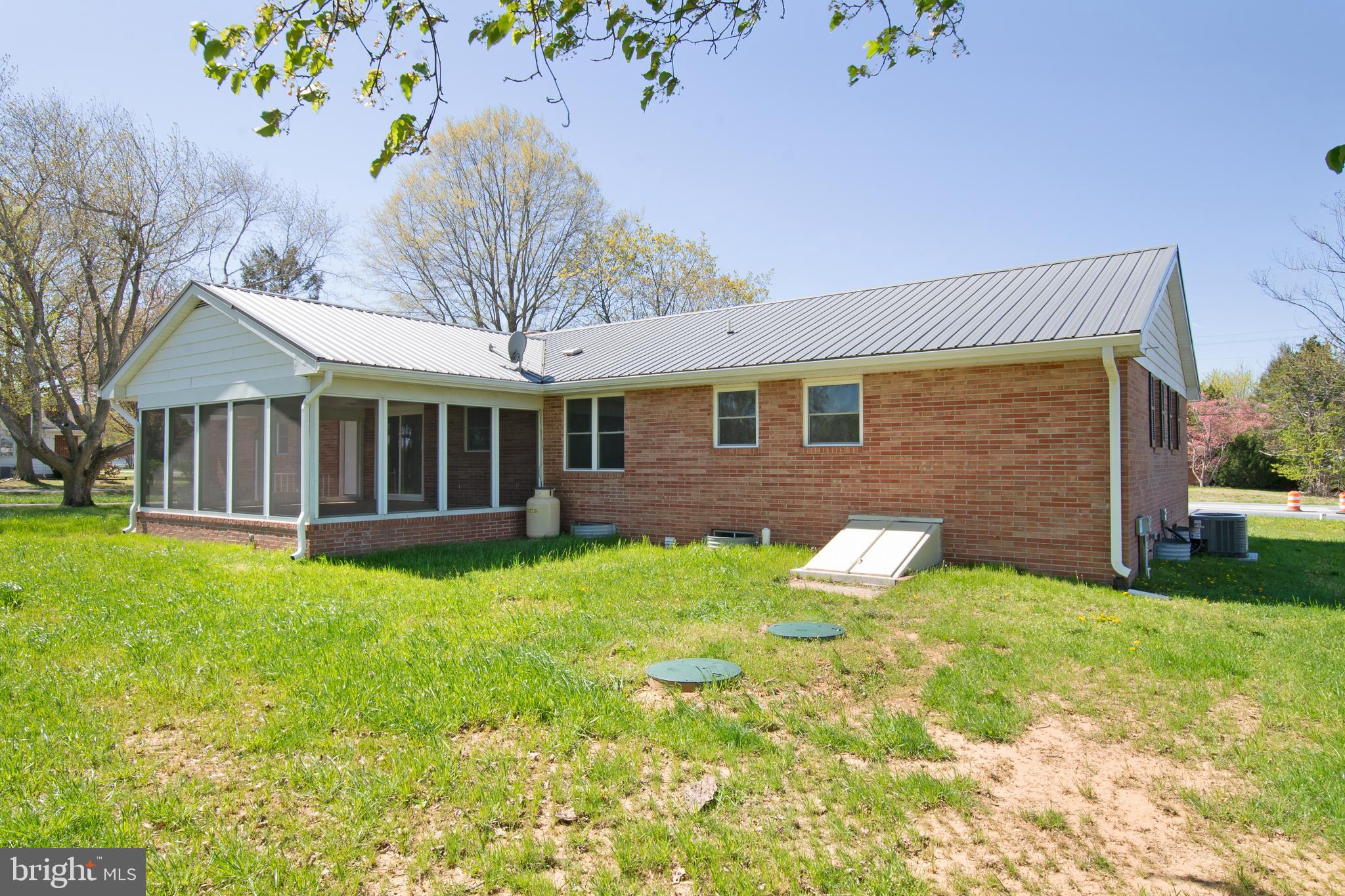 26854 Broadkill Road Milton, DE 19968 - Photo 6 of 56 a brick house with garden in front of it