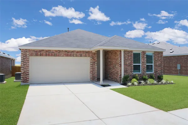 a front view of a house with a garden and yard
