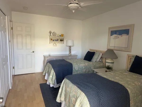 a bedroom with bed and wooden floor